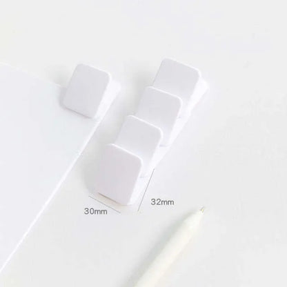 Square plastic photo holder in black, white, and transparent colour options on desk