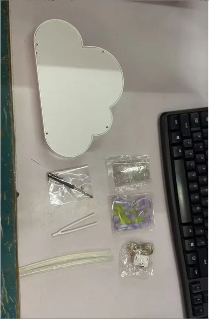 DIY tulip-shaped night lamp kit with LED lights and mirror surface in assorted colours on a desk.