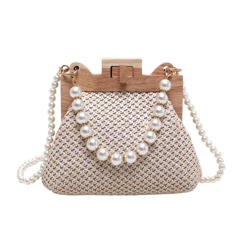 Women's Straw Woven Shoulder Bag with Pearl Chain Strap, featuring an internal zipper organiser and a soft, horizontal square silhouette for daily essentials