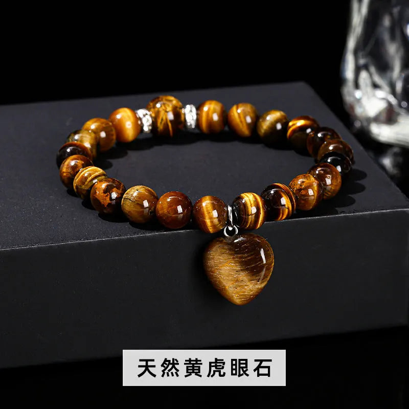 Handmade women's bracelet with natural gemstone beads and a silver love pendant charm.