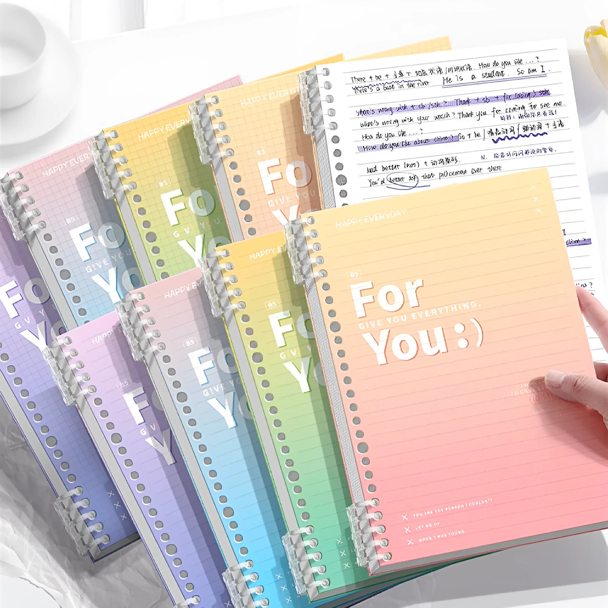 Removable coil gradient notebook in blue with PP cover and wood-free paper, showing coil binding mechanism
