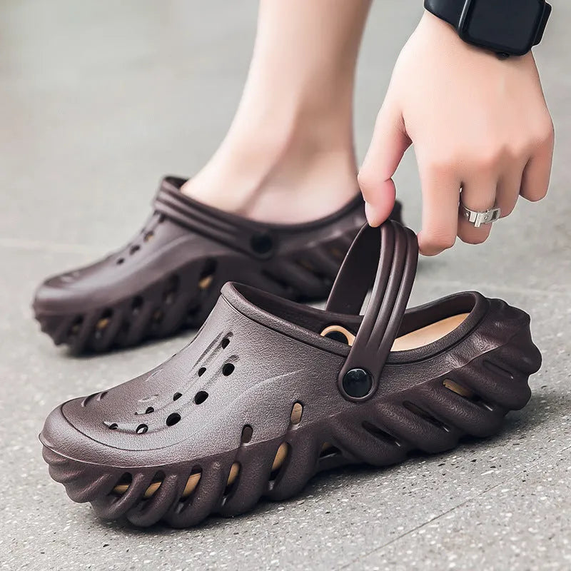 Men's beige slipper sandals with hollow-out design and textured non-slip sole, side view.
