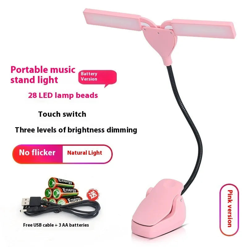 Black music stand light with flexible neck attached to metal music stand, illuminating sheet music