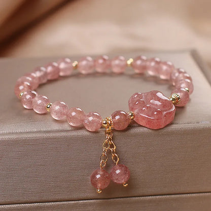 Double-layer strawberry quartz crystal bracelet with lucky cat charm and red cat's eye flowers design.