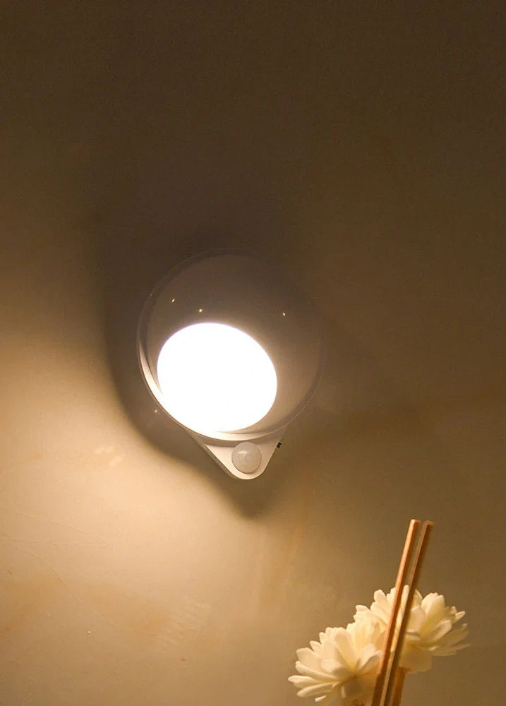 Wireless motion sensor light with USB charging port and adhesive mounting for wall installation