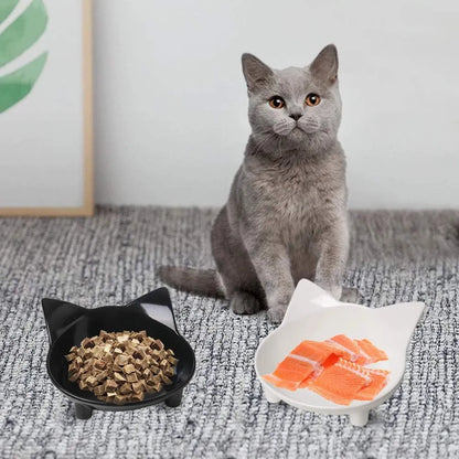 Black shallow melamine pet bowl with non-slip rubber base on a kitchen floor