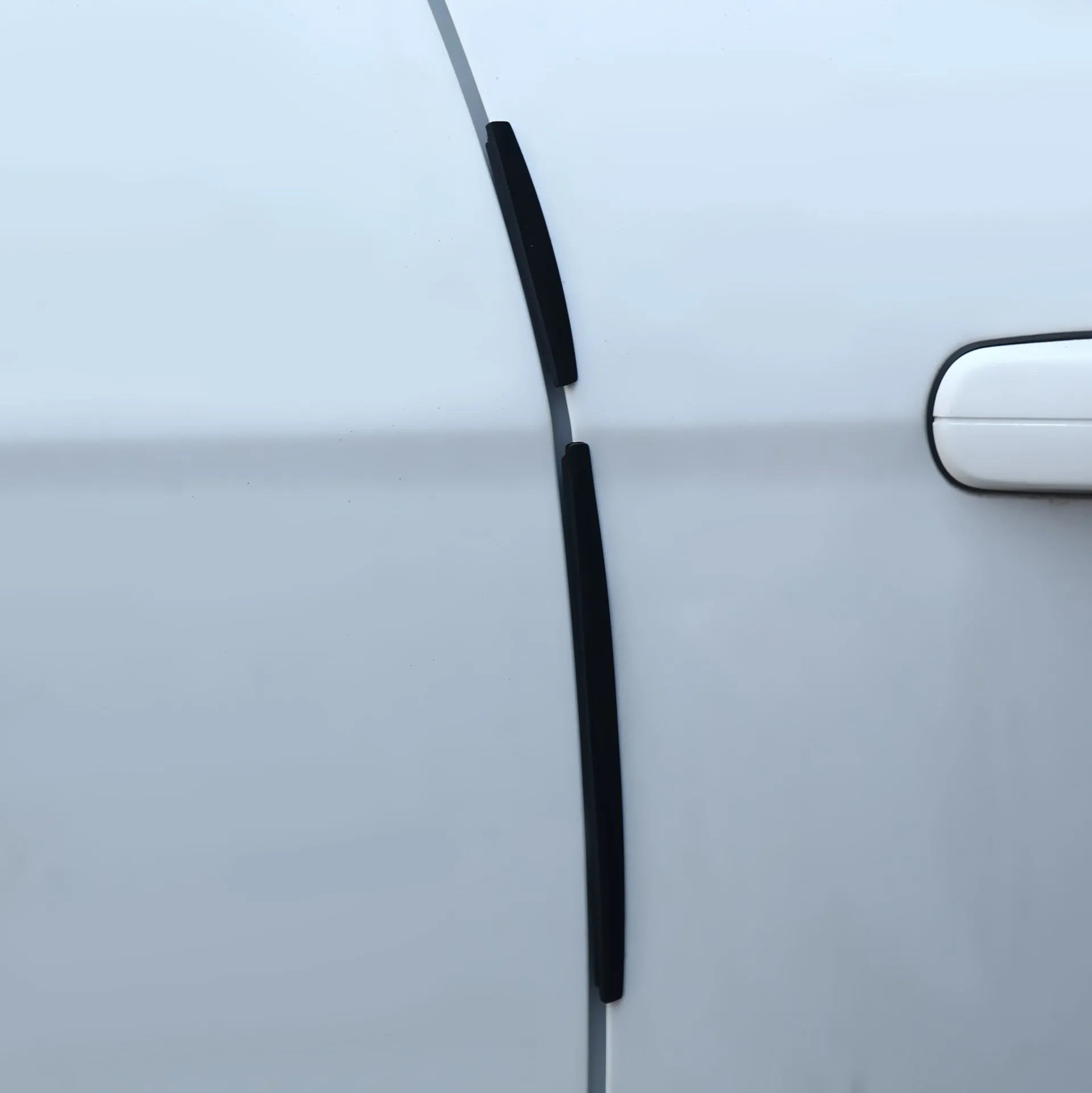 White plastic car door edge protection strip measuring 1.5cm wide and 3mm thick