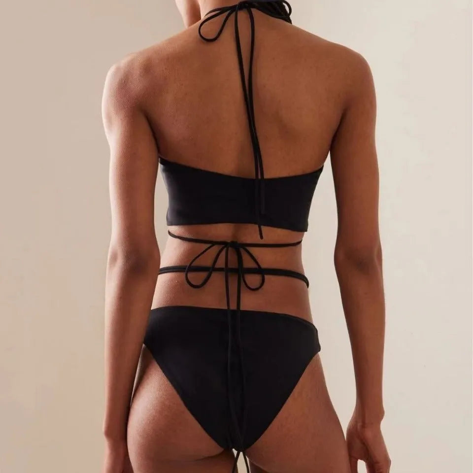 Women's black lace-up split bikini swimsuit with adjustable front and matching briefs