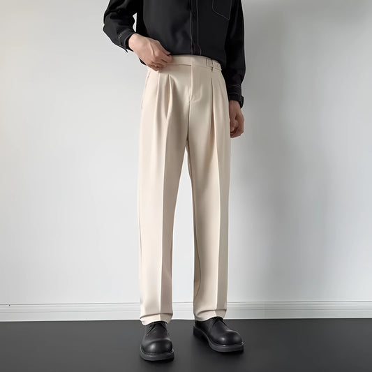 Men's apricot and black straight-leg loose fit suit trousers on a hanger.