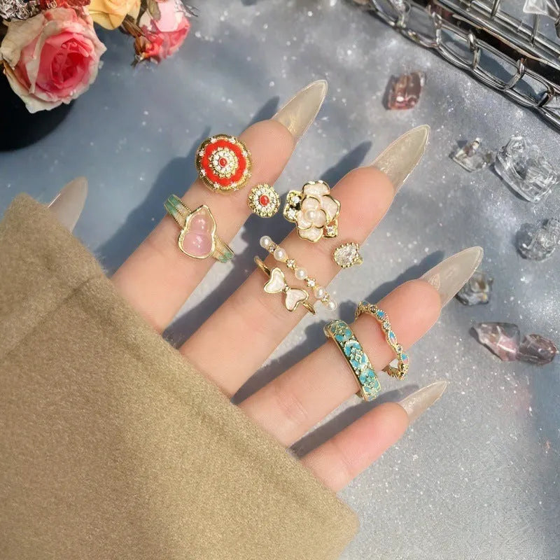 Adjustable copper gourd ring with zircon stones showing flower and bow design elements