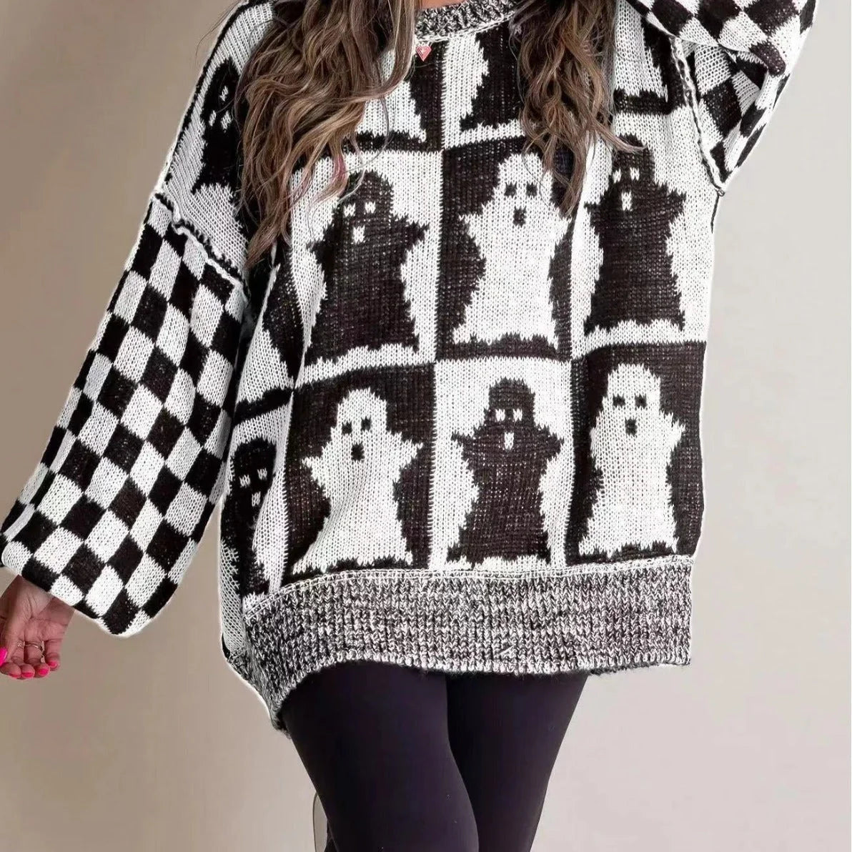A stylish Halloween sweater featuring a unique pumpkin and ghost graphic design, available in a variety of fashion-forward colors.