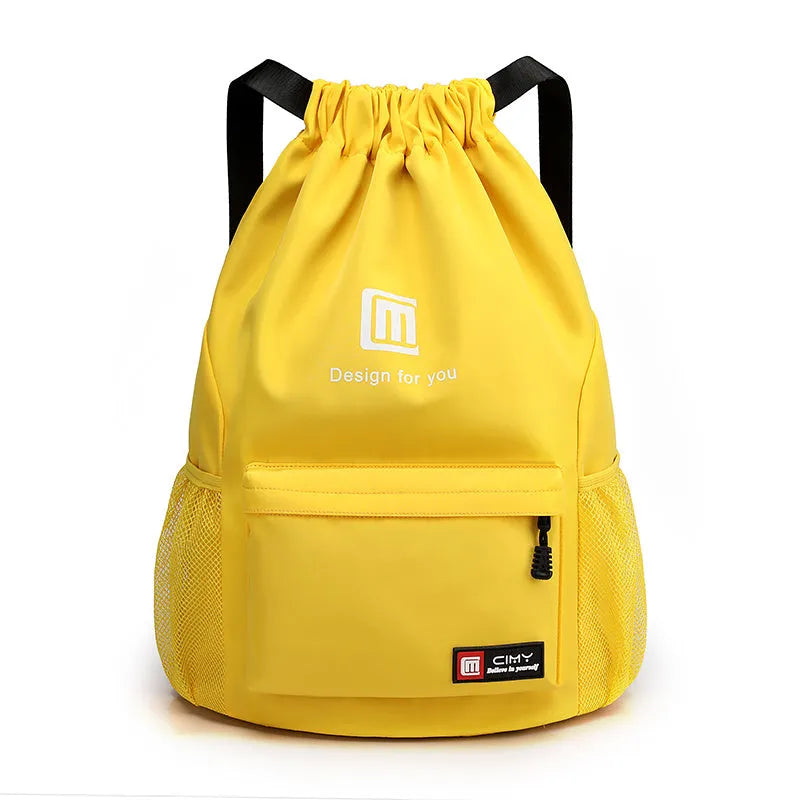 Large bucket-shaped travel backpack in blue with drawstring closure and soft black shoulder straps.