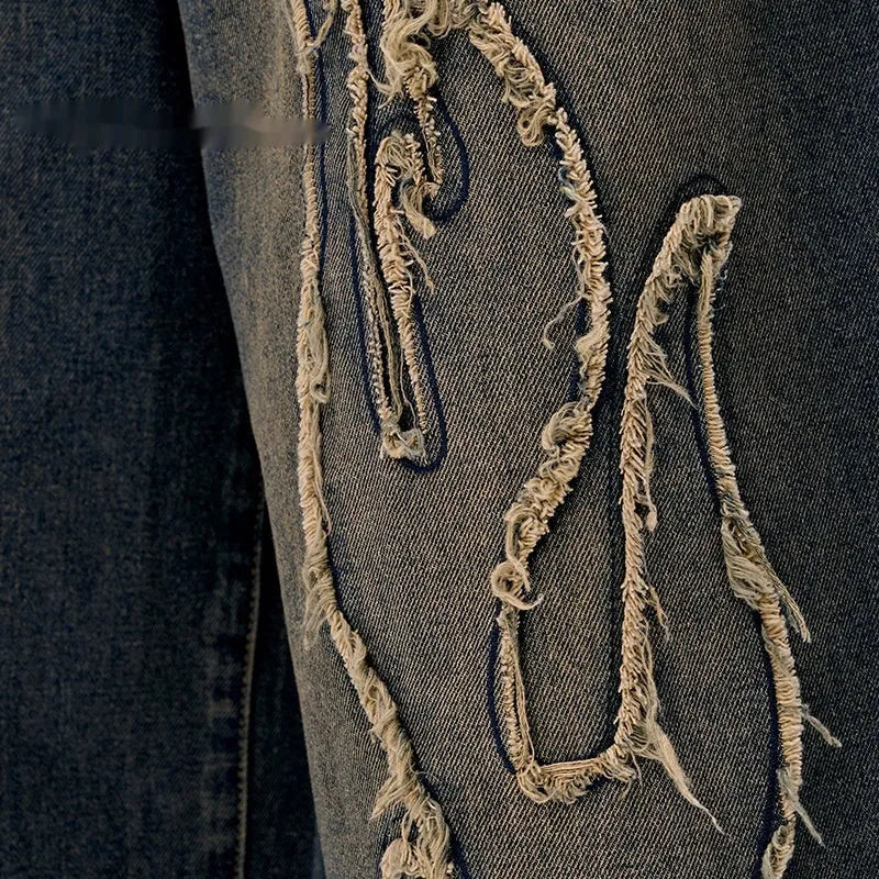 Men's black denim shorts with a cropped flame embroidery patch on the leg.