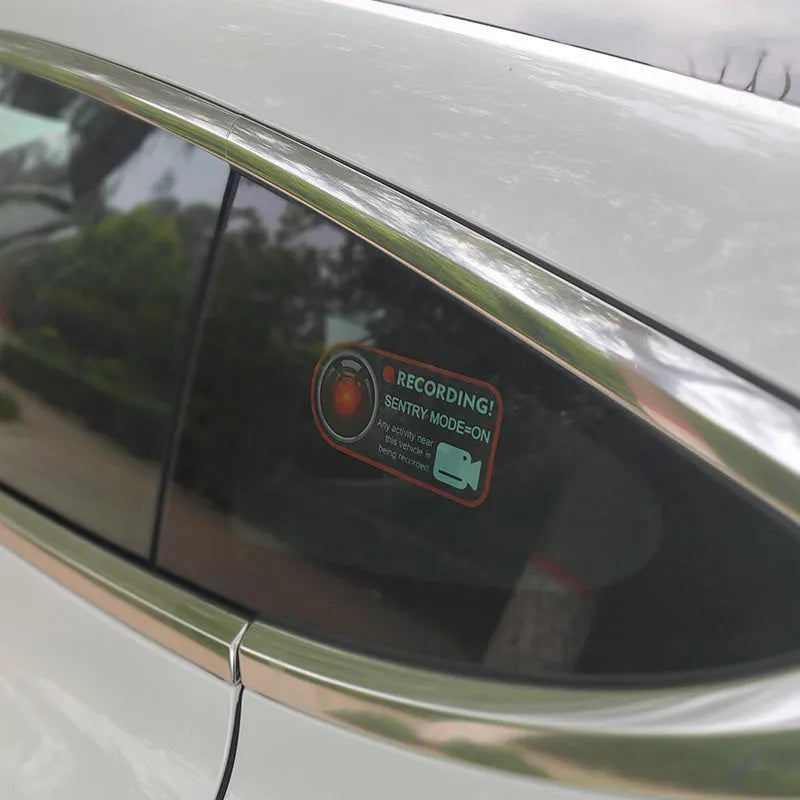 Tesla Sentry Mode electrostatic warning sticker measuring 11cm by 5cm with English security text