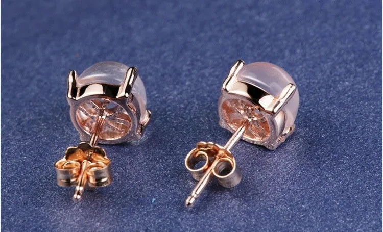 Women's drop-shaped stud earrings with synthetic rose quartz inlay and rose gold plating.