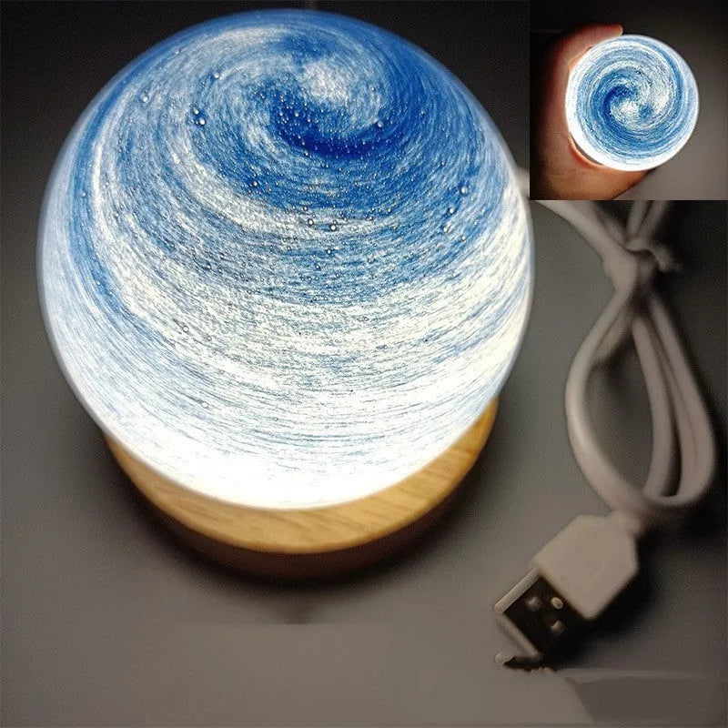 Planet-shaped USB night light with adjustable dimming in 12 colour options on its base.