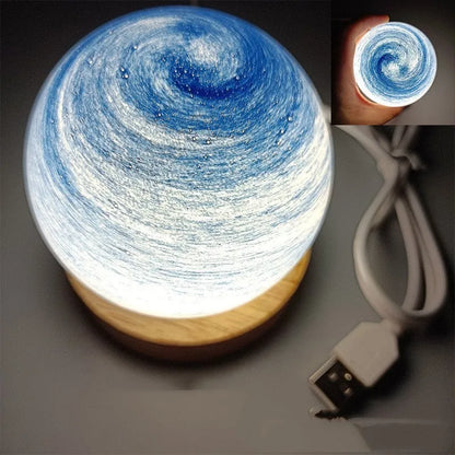Planet-shaped USB night light with adjustable dimming in 12 colour options on its base.