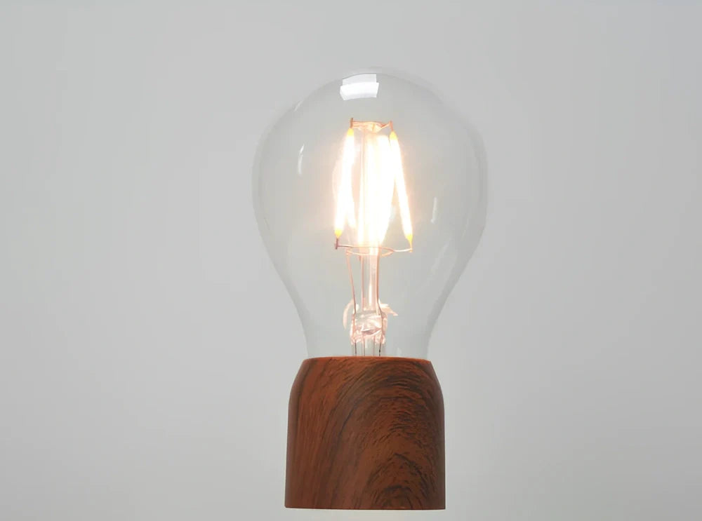 Magnetic levitation bulb floating above imitation wood base with international plug options