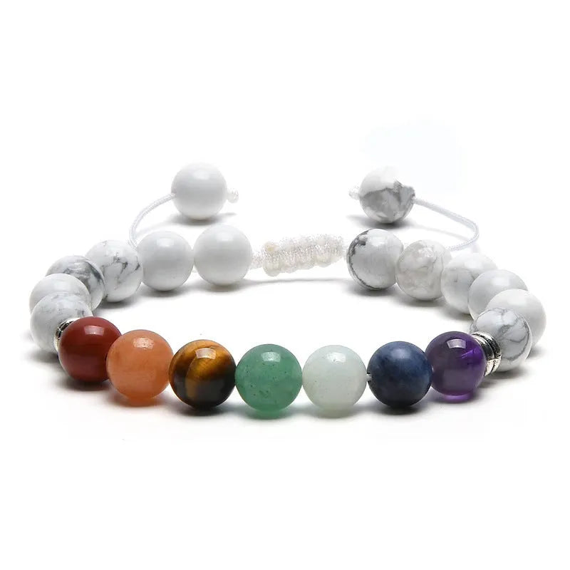 Close-up of a women's flat knot braided healing bracelet hand-woven with colourful gemstones.