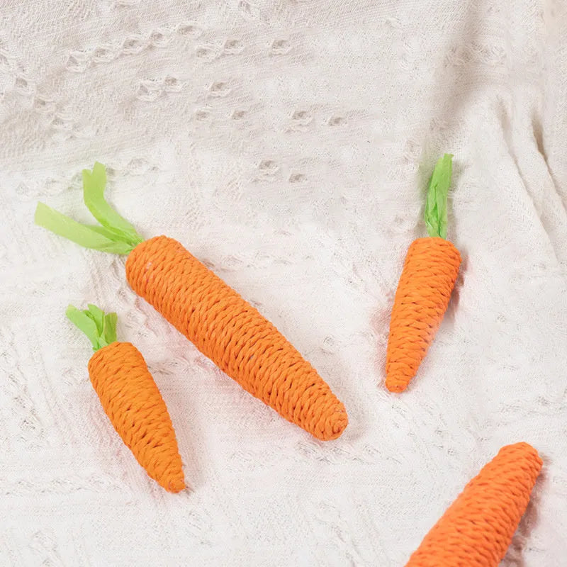 Set of interactive cat toys including carrot bites, paper toys, ringing stones, and sticks in two sizes.