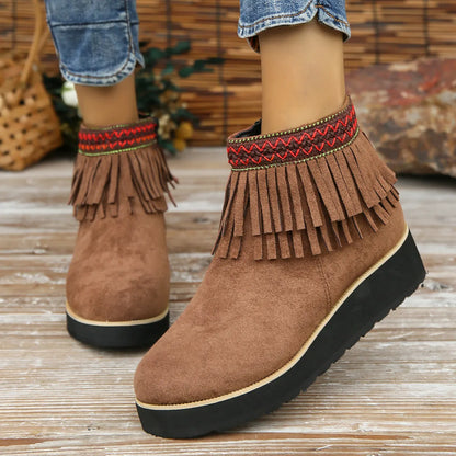 Women's thick bottom wedge bootie in suede with side zipper and tassel detail, available in multiple colours.