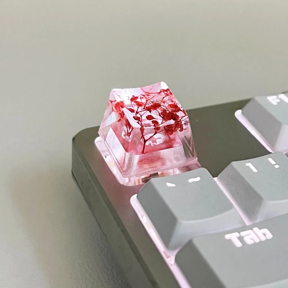A transparent resin keycap with a starry sky design inside, shown in a green colour variant.