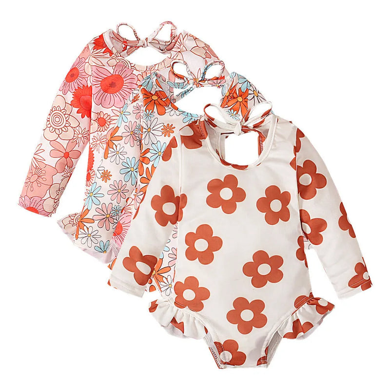 Girl's patterned crew neck open back swimsuit with floral graphic print, available in white, orange, and orange red colour options, made from polyester fibre in children's sizes 70 to 110 yards, featuring a briefs style with detailed Asian size guidance