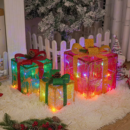 Set of three sparkling LED-lit Christmas gift boxes with red bows on a snowy porch.