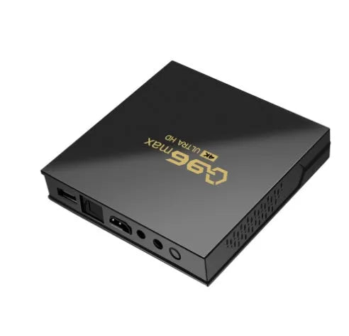 Q96 MAX Android TV set-top box with remote control and HDMI cable on a wooden surface.