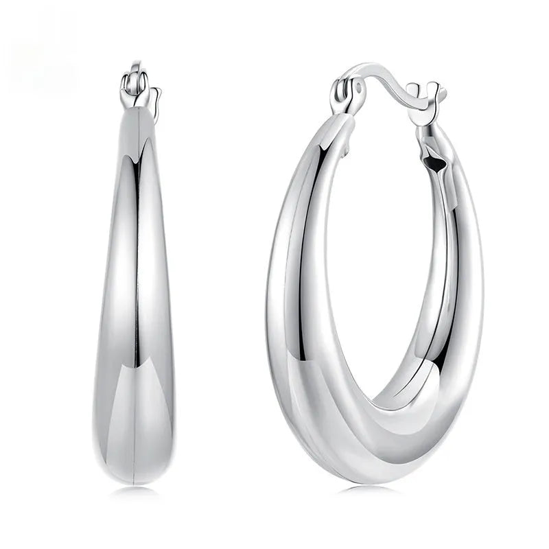 Copper alloy ear clip earrings with geometric ring design and silver posts in three sizes.