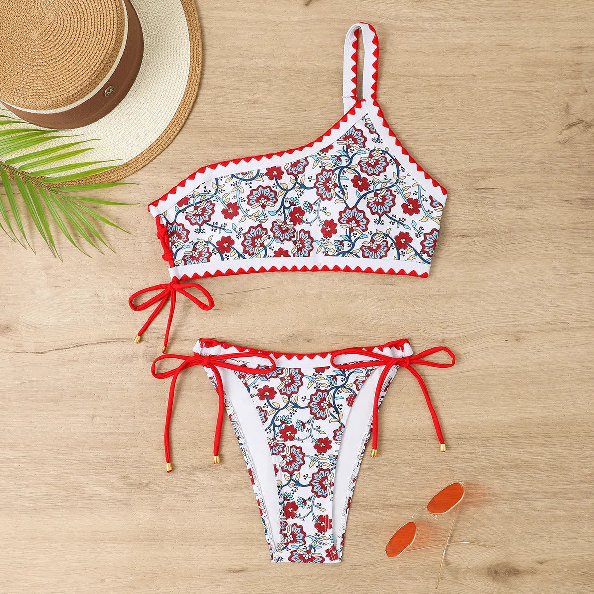 Blue one-shoulder floral bikini set on a mannequin, showing front and back views.