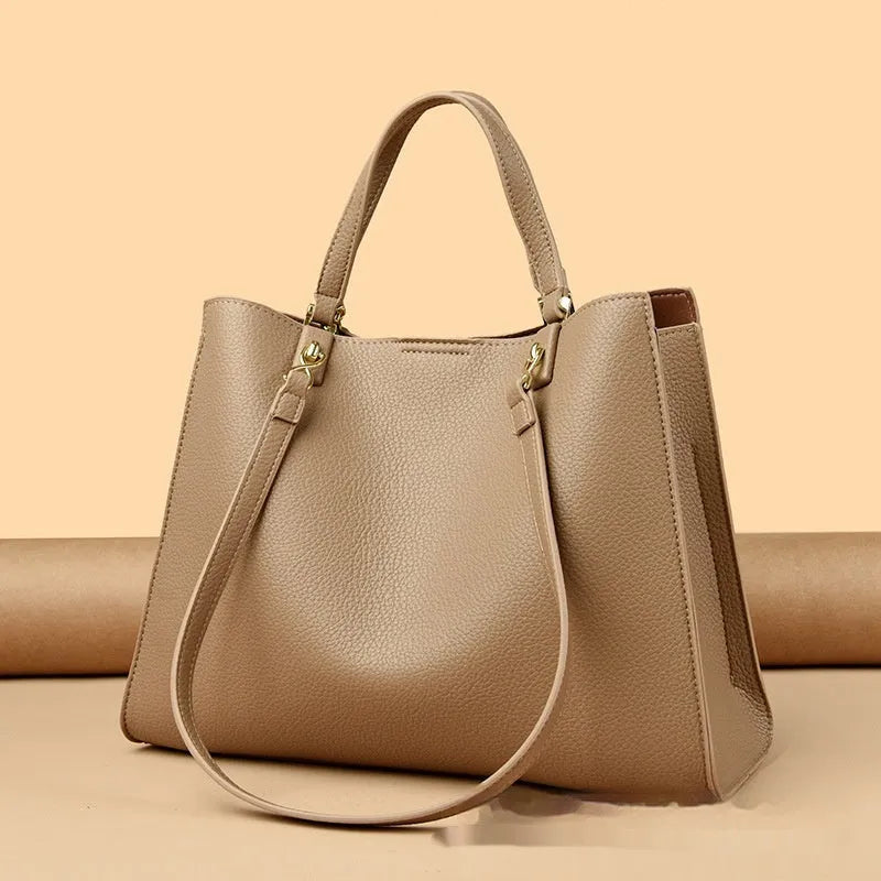 Women's horizontal square messenger tote bag in PU leather with crossbody strap and internal compartments.