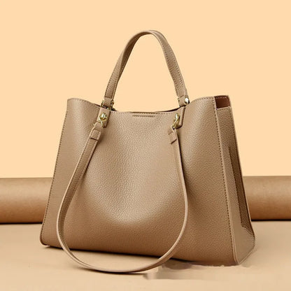 Women's horizontal square messenger tote bag in PU leather with crossbody strap and internal compartments.