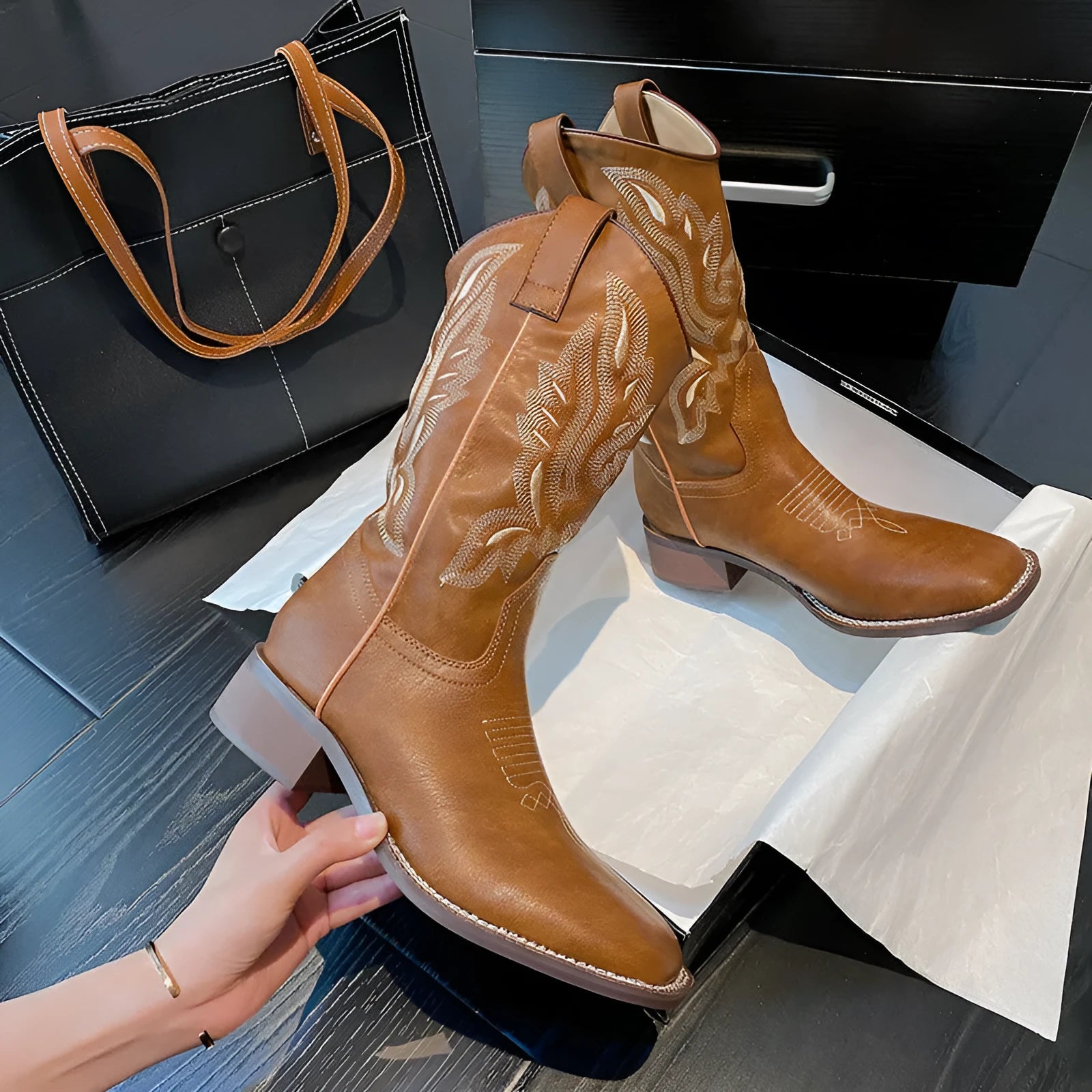 Brown women's mid-calf Martin boots with embroidered detail on the shaft.