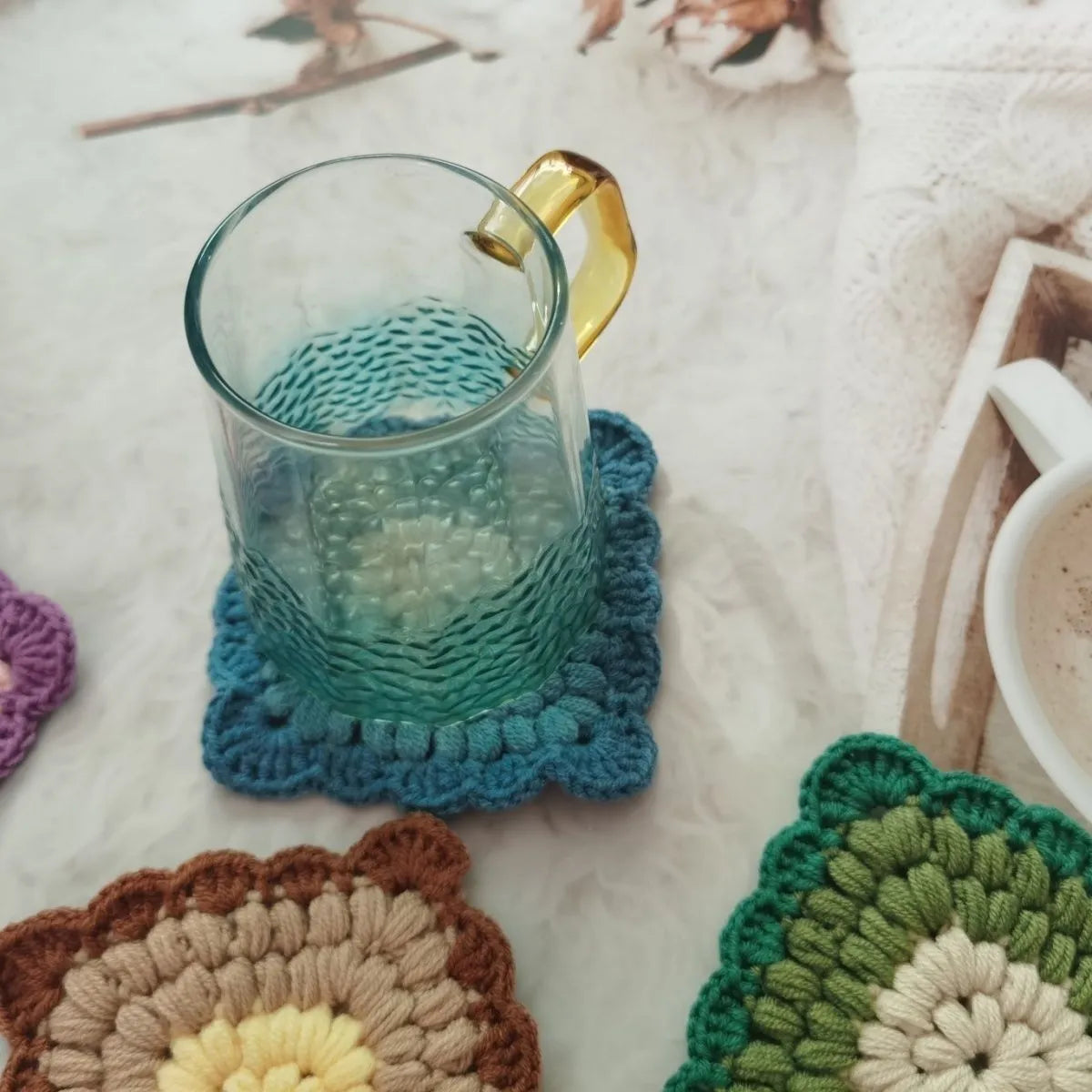 Crocheted wool cup coaster with grandmother lattice pattern in selected colour