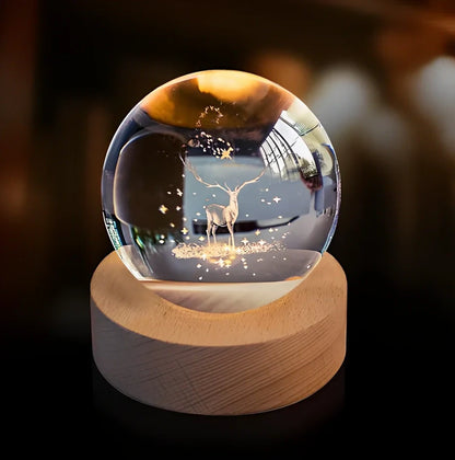 3D crystal ball night light projecting solar system pattern on wooden base with astronaut figurine