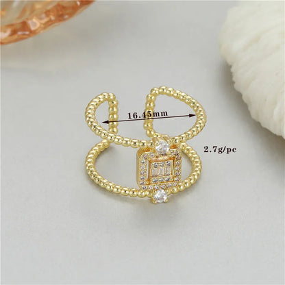 Adjustable open ring with asymmetric U-shaped design in 14K gold-plated copper, showing opening mechanism