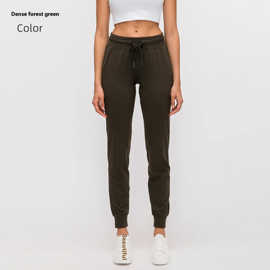 Women's high waist yoga pants with drawstring waistband in Belgian blue colour, showing stretch fabric during yoga pose
