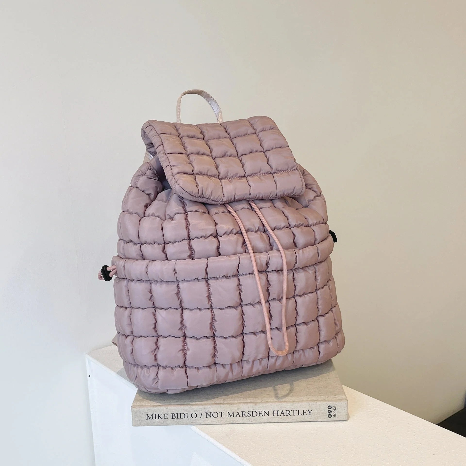Soft, quilted puffer backpack in a variety of colors, perfect for autumn and winter wear