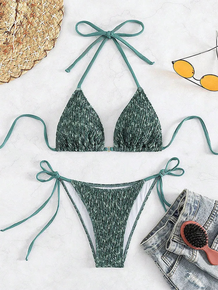 Women's green halterneck swimsuit with backless design and matching shorts
