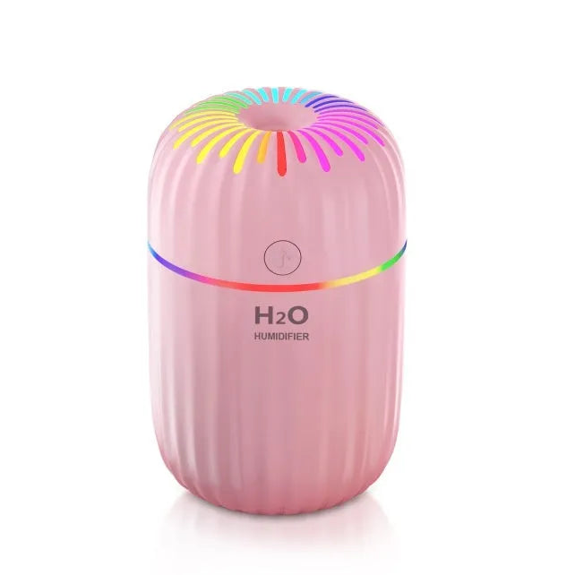White USB mini humidifier with 300ml tank on desk beside laptop showing compact 75x75x116mm size