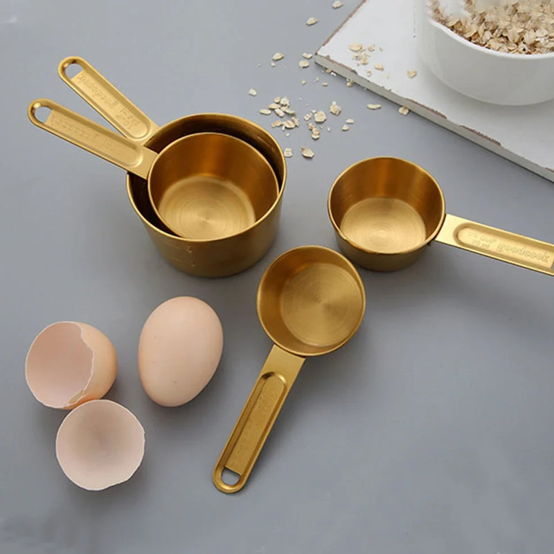 Stainless steel measuring spoons and cups set with engraved measurement markings that won't rub off, featuring 8 pieces including 4 cups and 4 spoons with removable storage rings for organised kitchen use