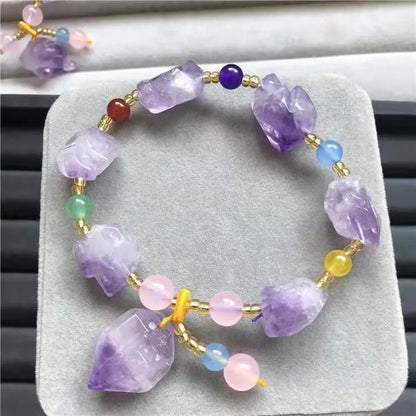 Natural shaped purple amethyst bracelet for women with a fu character bead on a white background.