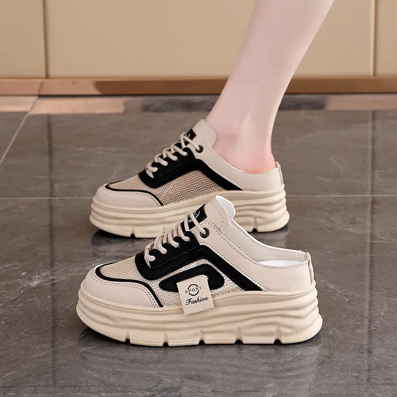 Women's black mesh half slipper with round toe and rubber sole, shown on a white background.