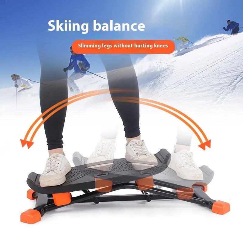Black JS101A mini fitness skiing machine with elastic hand straps on a home floor, showing compact size.