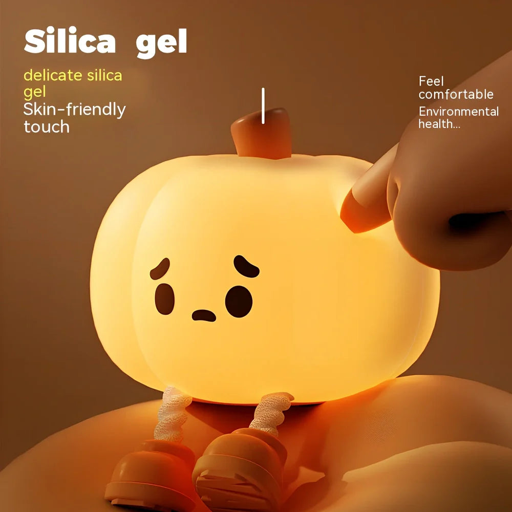 Orange silicone pumpkin night lamp measuring 98x105x83mm with built-in battery and USB charging port