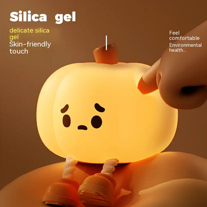 Orange silicone pumpkin night lamp measuring 98x105x83mm with built-in battery and USB charging port