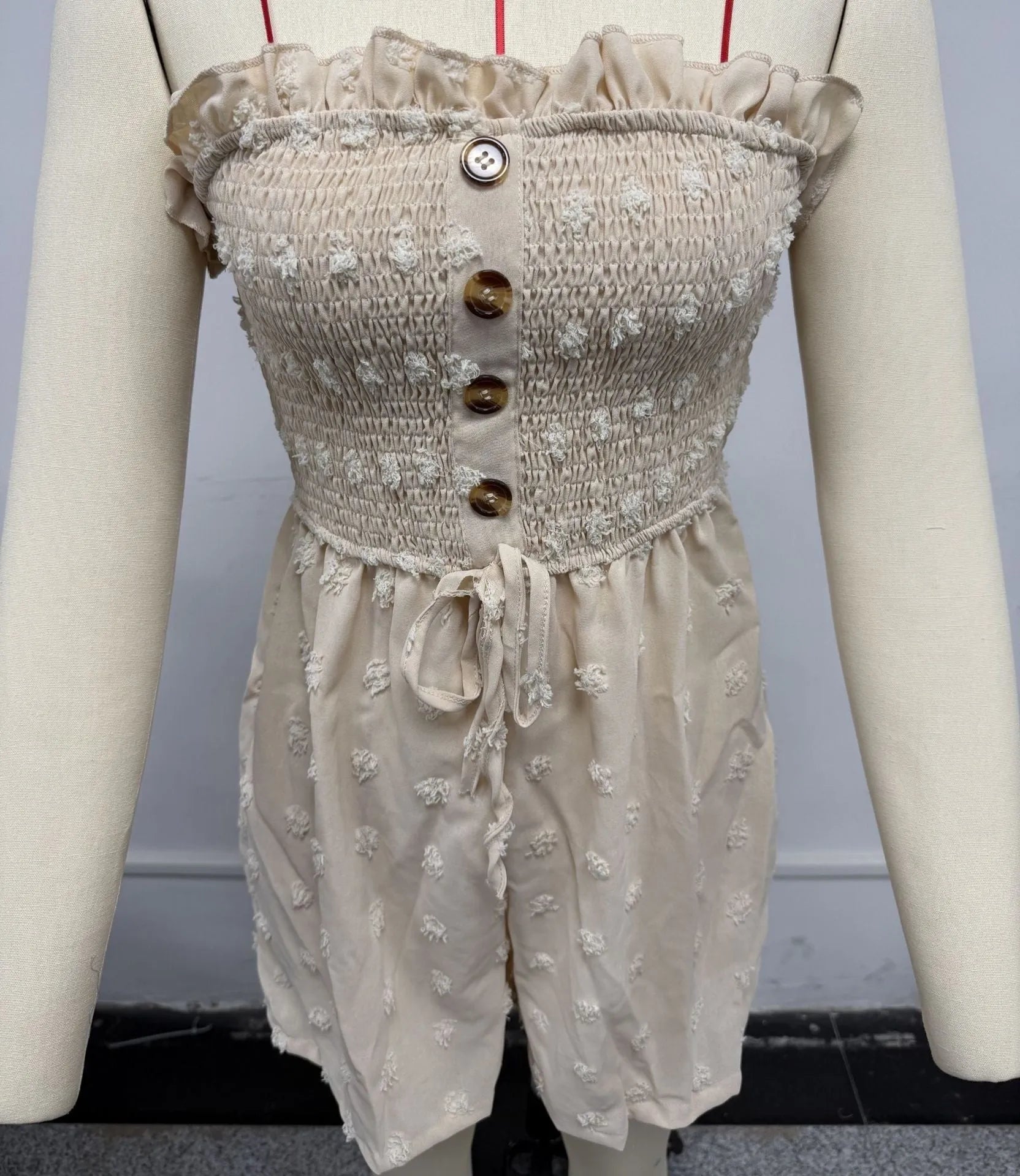 Women's off-shoulder sleeveless jumpsuit in polyester fabric with button detailing and mid-waist design