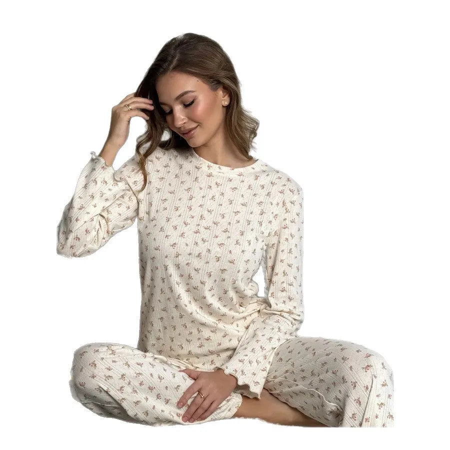 White floral print women's loungewear set with bell sleeve top and wide-leg trousers laid flat.