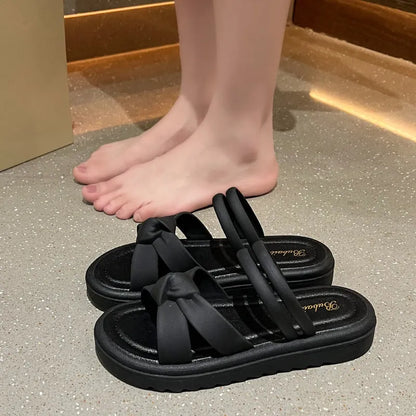 Women's black PVC sandals with thick soft back, floral detail, and injection moulded sole